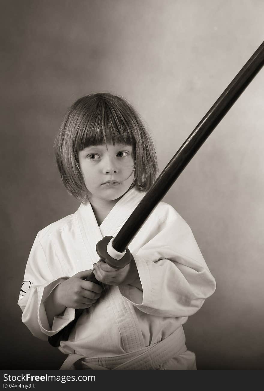 Little girl practice karat with the sword. Little girl practice karat with the sword