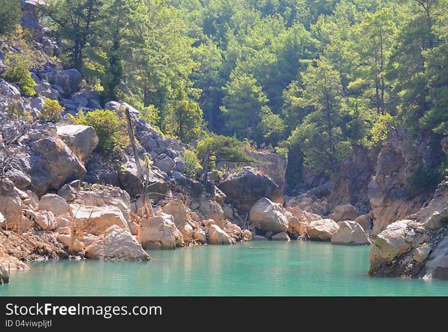 Rocky mountains, trees, sky and water. Rocky mountains, trees, sky and water