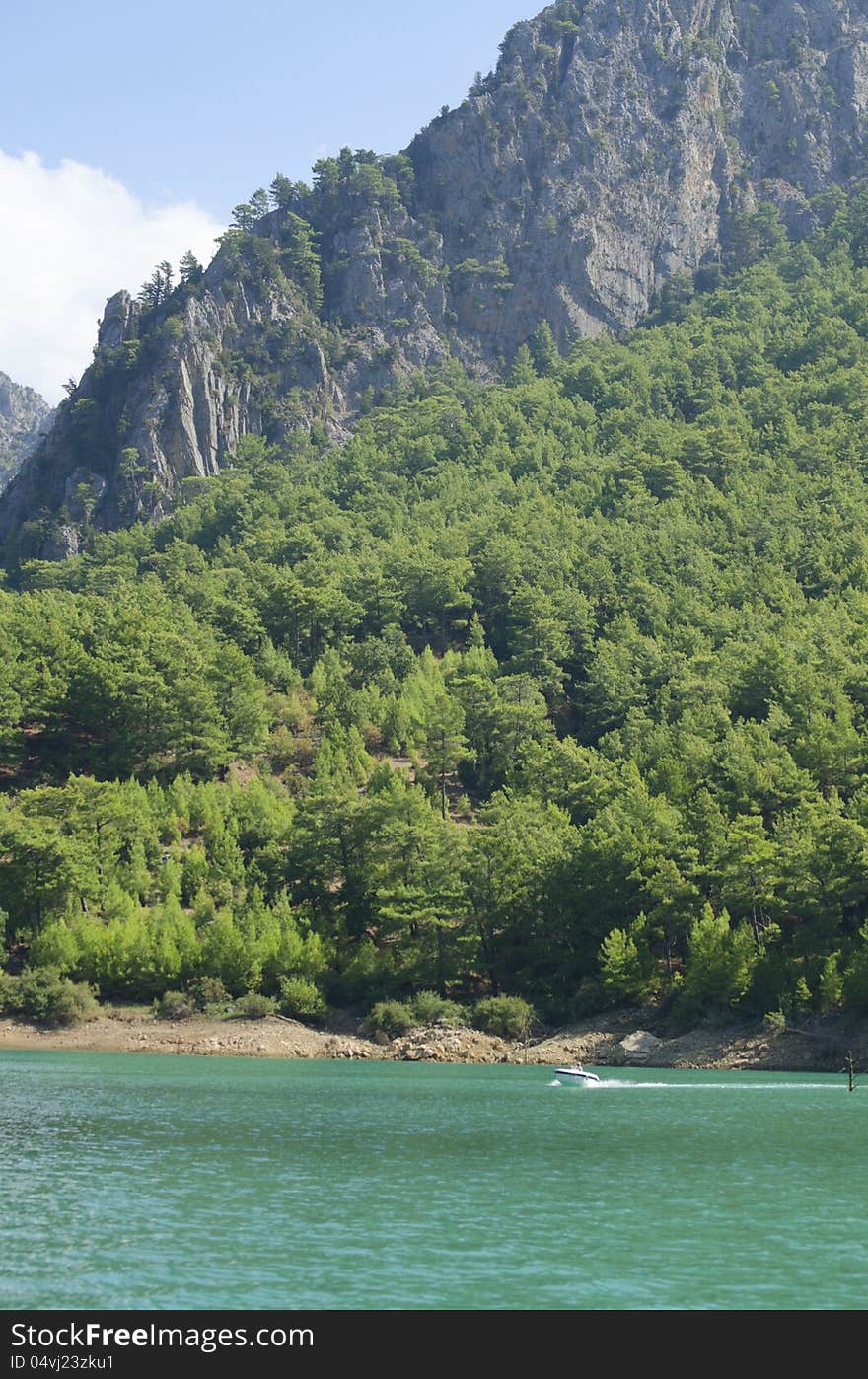 Rocky shore with trees against the blue sky. Rocky shore with trees against the blue sky