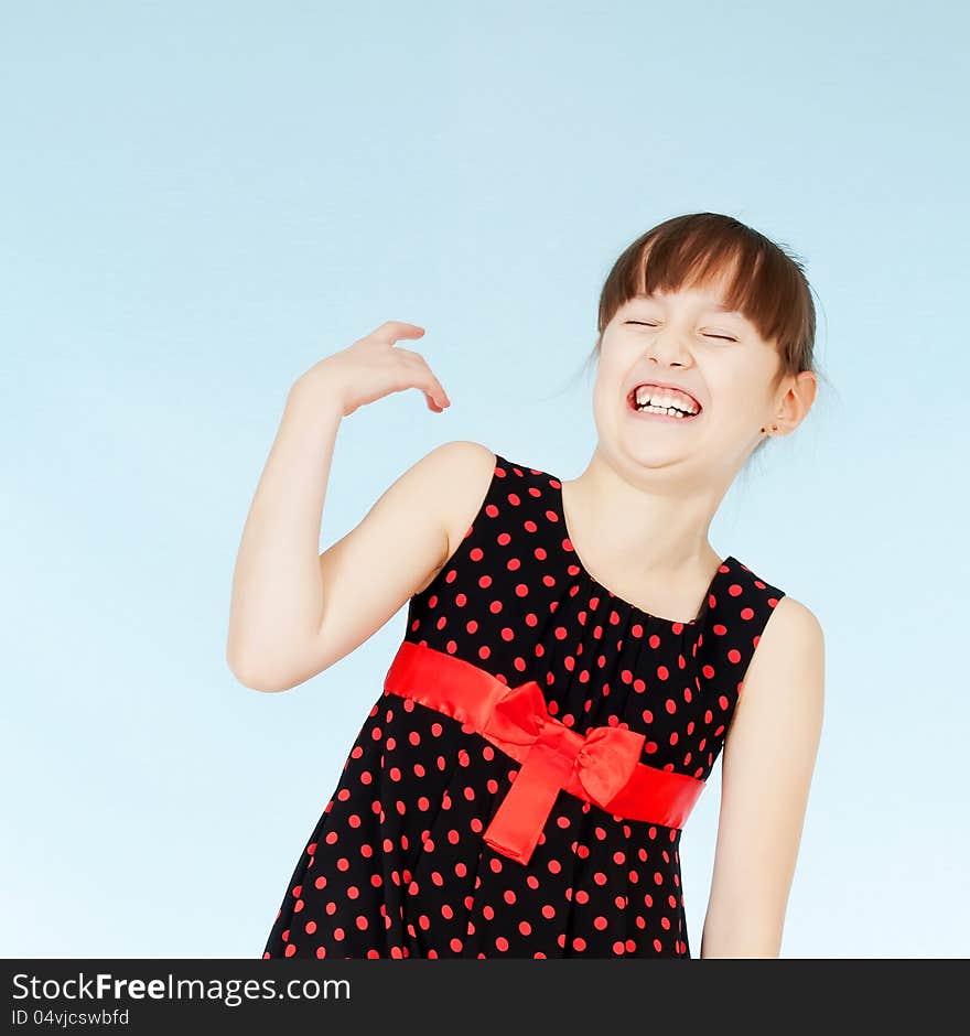 Happy young girl in a black and red dress smiling with his head with a friendly look. Happy young girl in a black and red dress smiling with his head with a friendly look