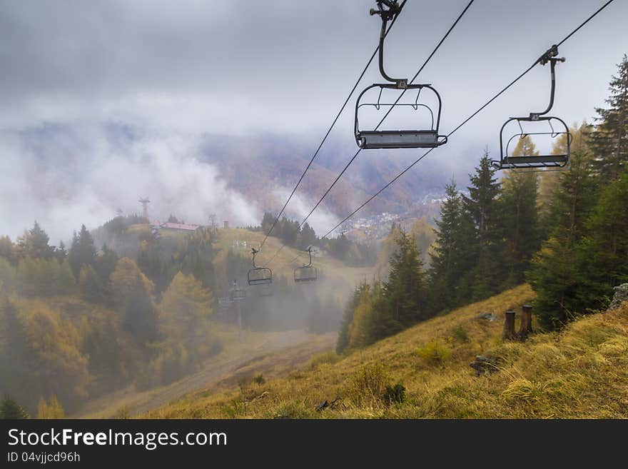 Chair lift in foggy mountain