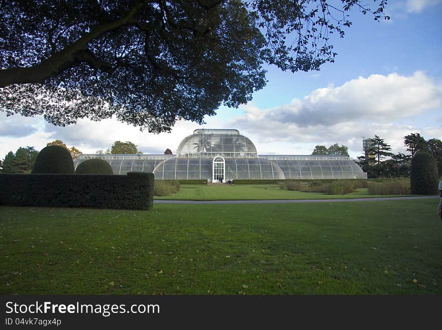 The famous glass Palm House at the Royal Botanical gardens at Kew. It was the first large-scale structural use of wrought iron. The structure's panes of glass are all hand-blown. The famous glass Palm House at the Royal Botanical gardens at Kew. It was the first large-scale structural use of wrought iron. The structure's panes of glass are all hand-blown.