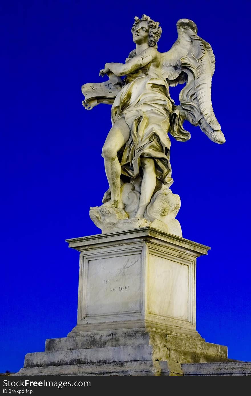 One of Bernini`s statue of angels (Angel with the superscription) on Ponte Sant`Angelo, in front of Castel Sant`Angelo in Rome