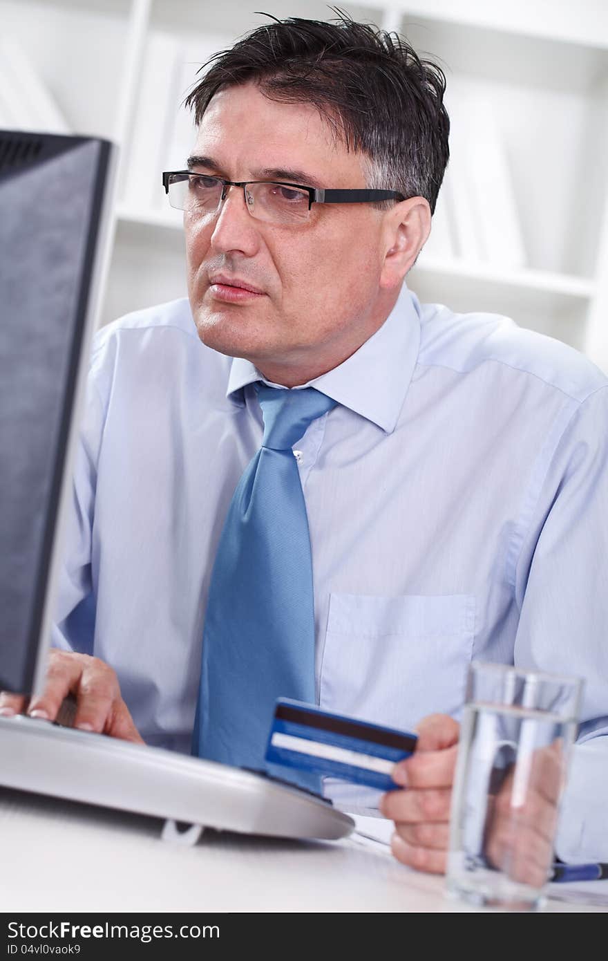 Senior man with credit cart shopping over internet. Senior man with credit cart shopping over internet