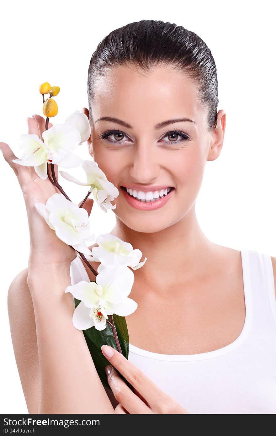 Beautiful Smiling woman posing with white orchid next her face. Beautiful Smiling woman posing with white orchid next her face