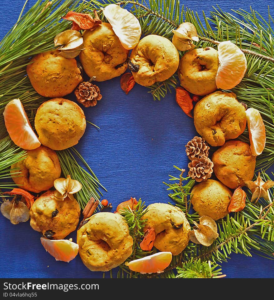 Christmas decoration made of baked rolls, tangerine slices and pine needles. Christmas decoration made of baked rolls, tangerine slices and pine needles