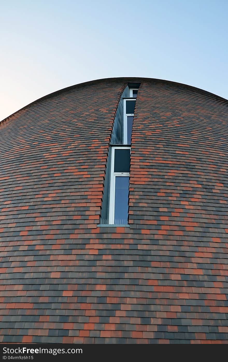 This image presents a detail from a rounded brick modern building. This image presents a detail from a rounded brick modern building