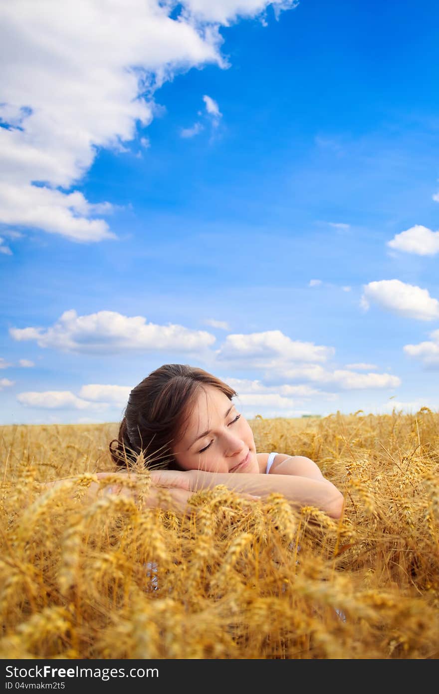 Pretty woman on yellow wheat field