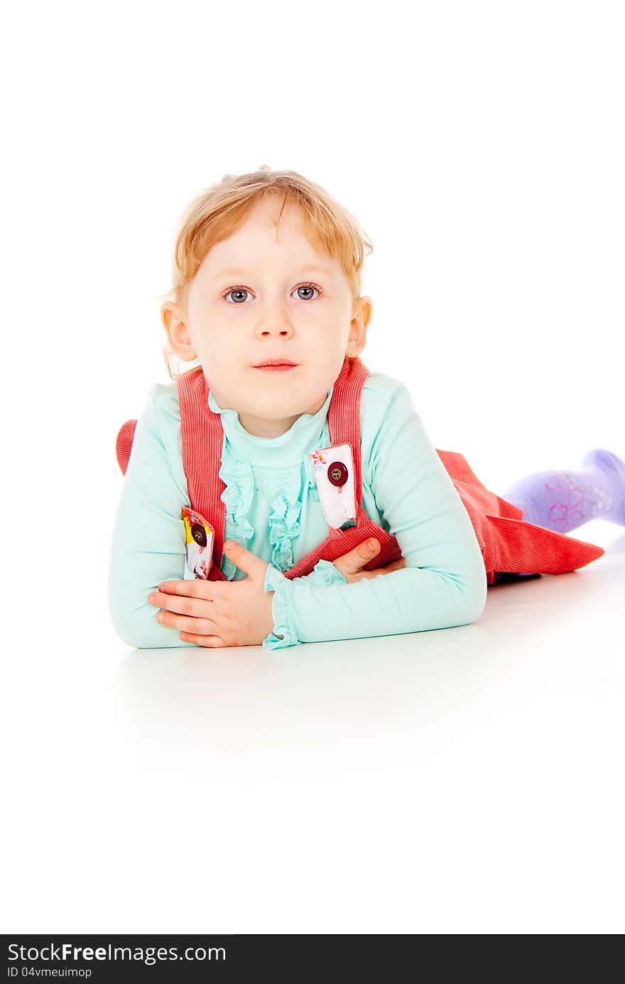 The little girl lying on the floor isolated on white background