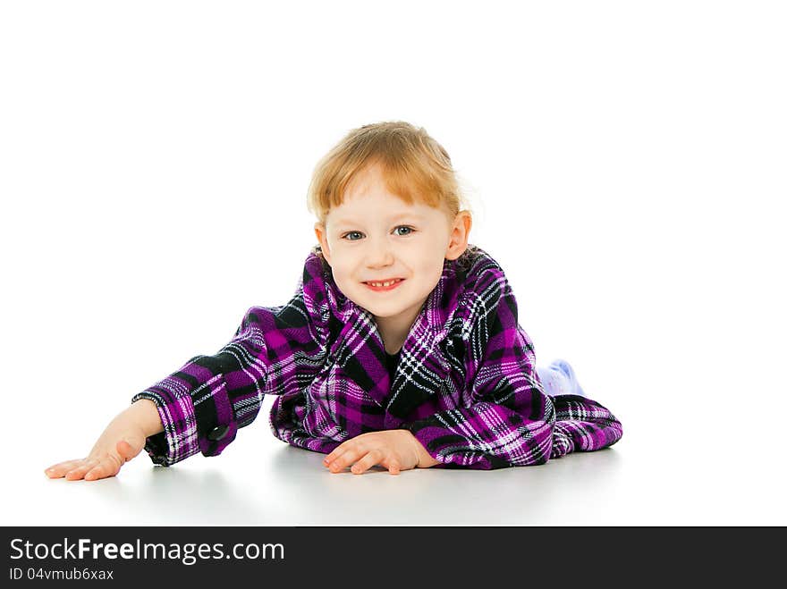 A little girl plays, lies isolated on white background