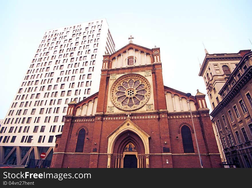 Wide view of Saint Joseph Cathedral surrounded by old and new buildings.Cathedral Plaza and old house.