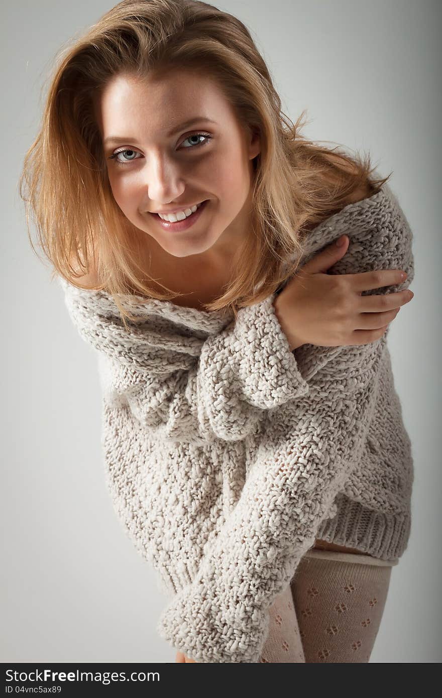 Beautiful young woman on gray background