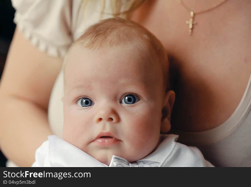 Delicate and feminine mother tenderly embracing her child. Delicate and feminine mother tenderly embracing her child