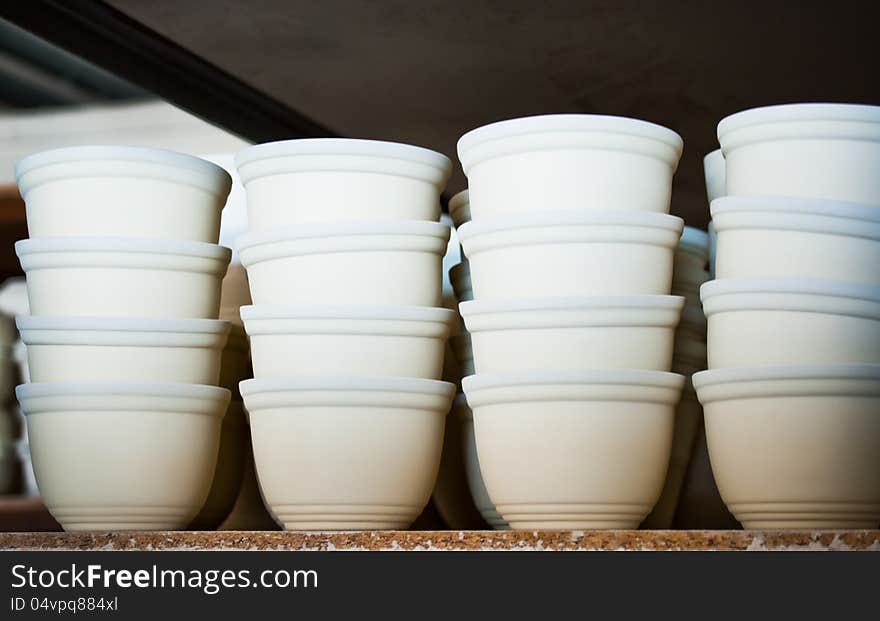 Ceramic vases. Piles of clay pots, covered glass glaze before firing. Manufacturing handmade pottery.