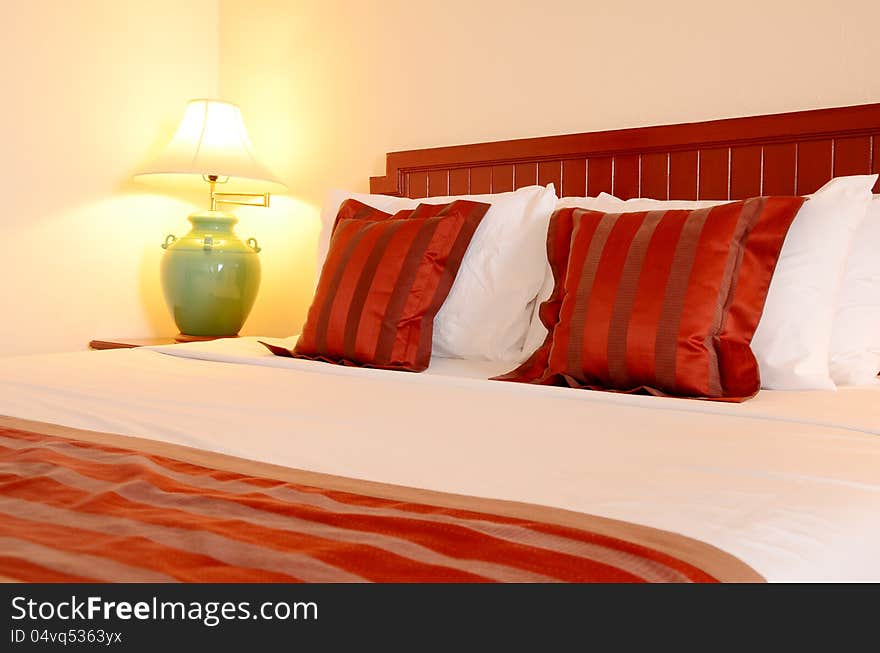 The bedroom decorated decorated in red and white with warm light . The bedroom decorated decorated in red and white with warm light .