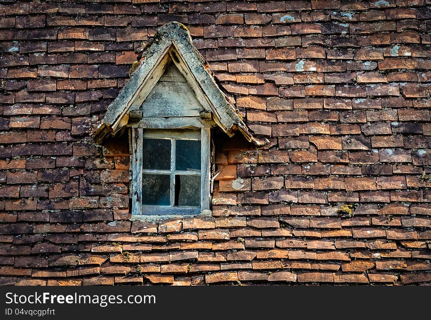 Old Orange Brick Roof With Broken Glass Winow