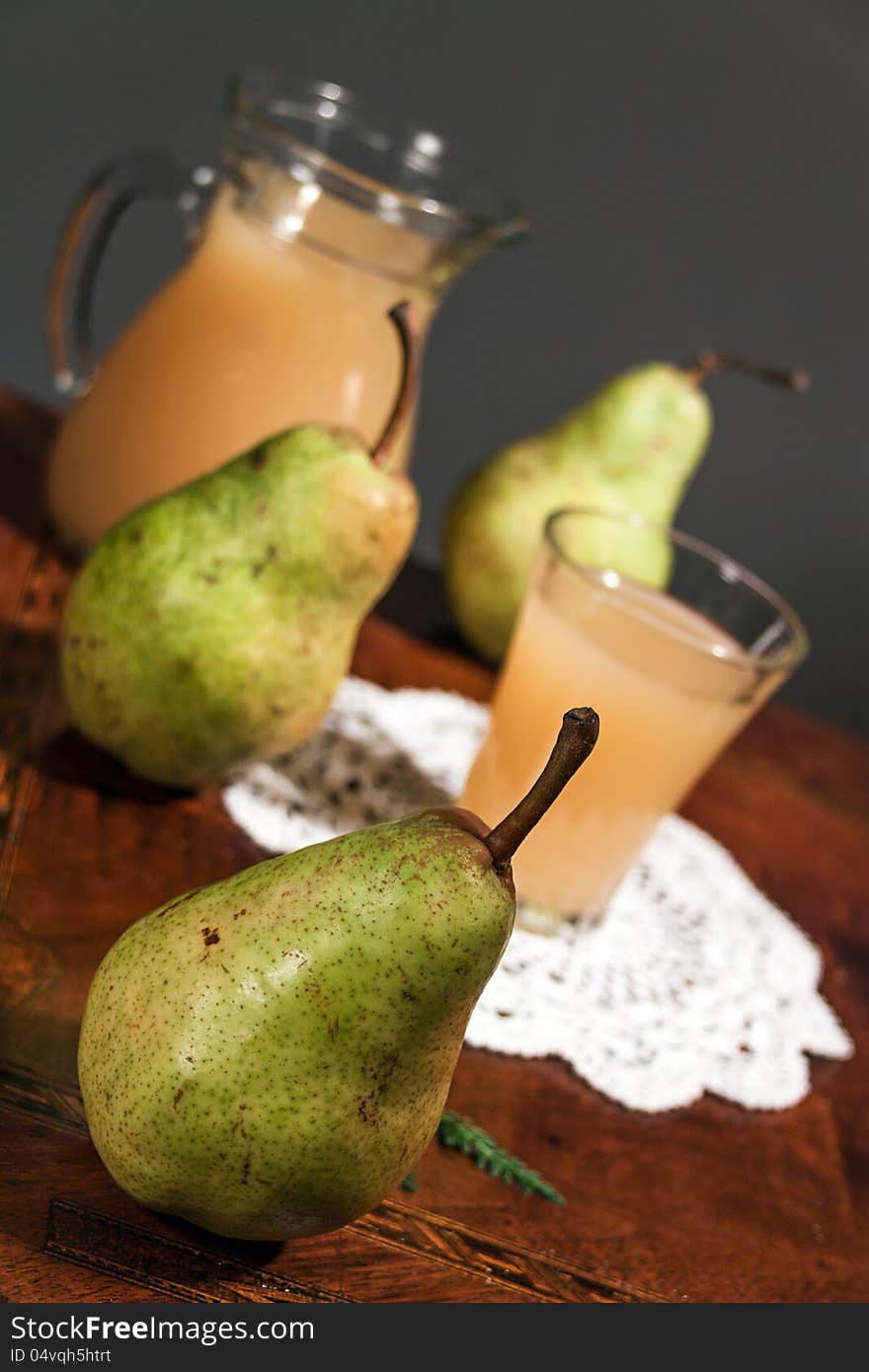 Pear juice with fresh fruit on wooden table