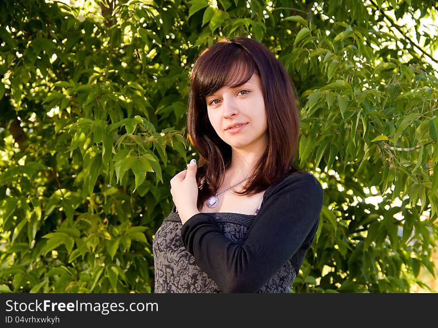 Beautiful girl stands on the nature