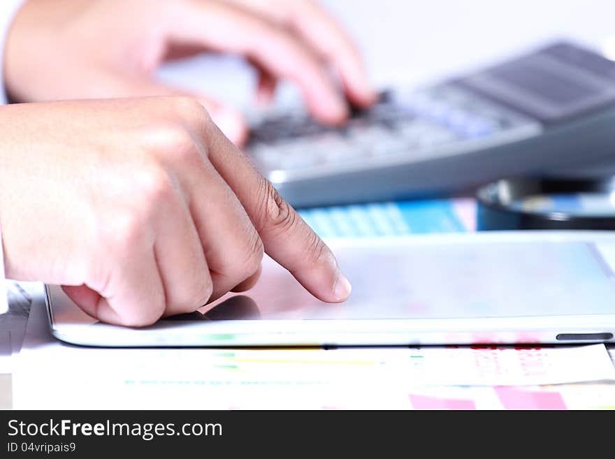 Businessman hand using tablet on the desk