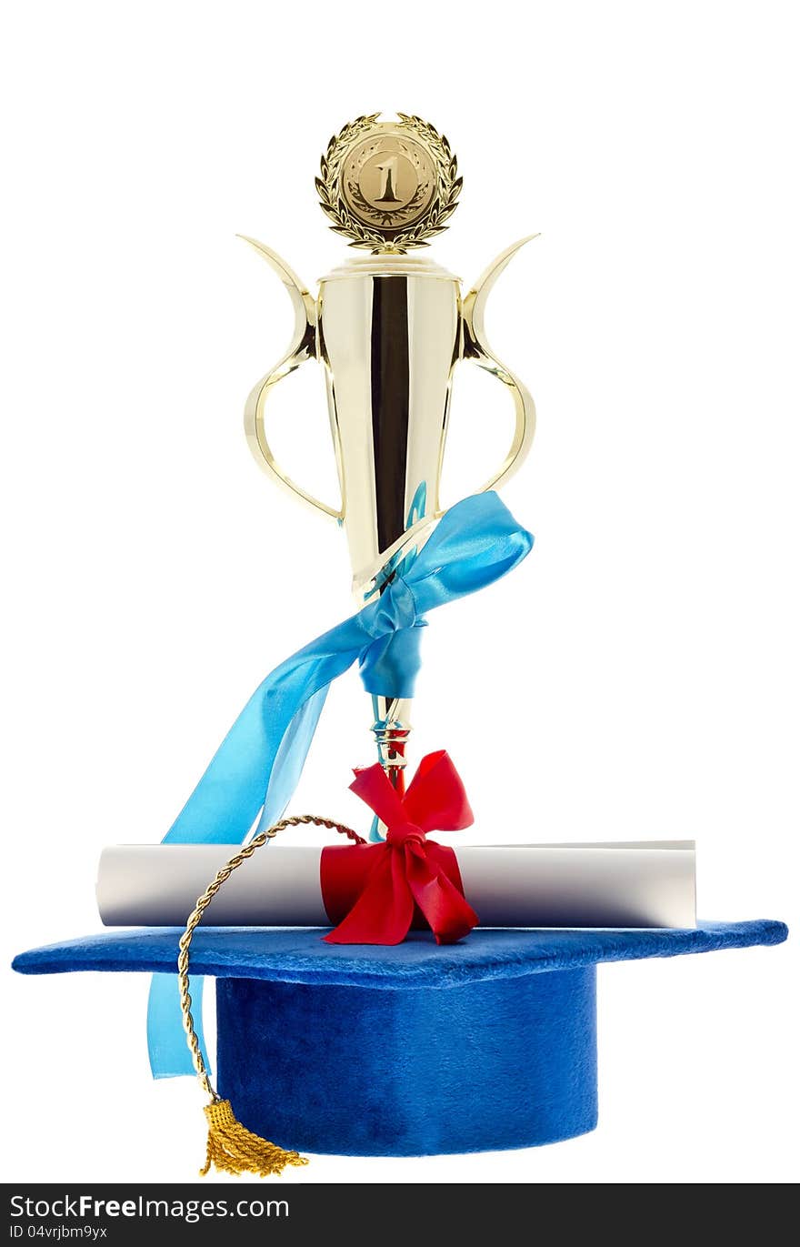 1st. place golden winner cup, blue graduate cap & diploma with a red ribbon isolated on white. 1st. place golden winner cup, blue graduate cap & diploma with a red ribbon isolated on white.