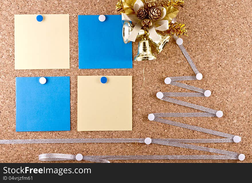 Corkboard with a New Year resolutions empty paper notes, Christmas wreath and improvised silver Christmas tree. Corkboard with a New Year resolutions empty paper notes, Christmas wreath and improvised silver Christmas tree.