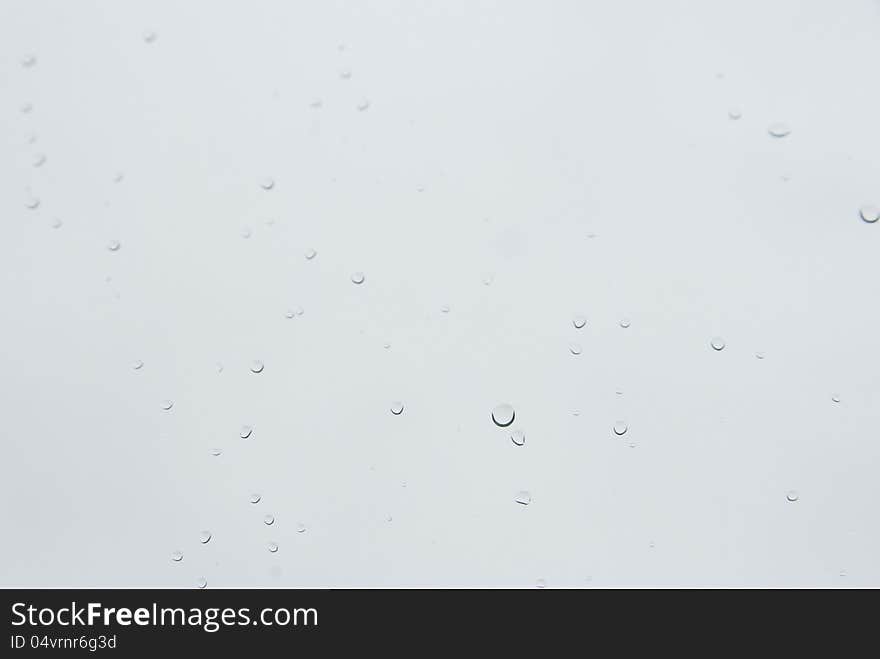 Raindrops on a window glass in a rainy day.