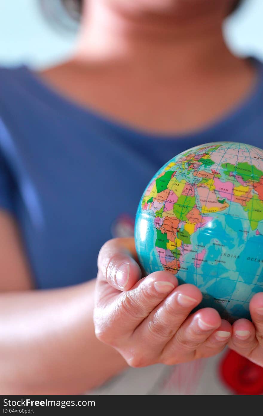 Earth globe in hand