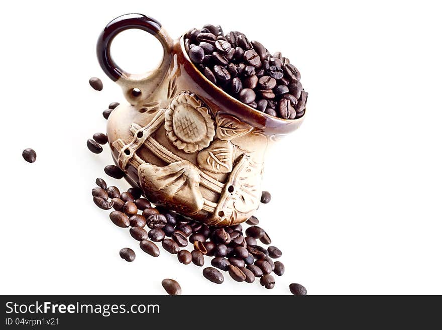 A hand made cup with coffee beans