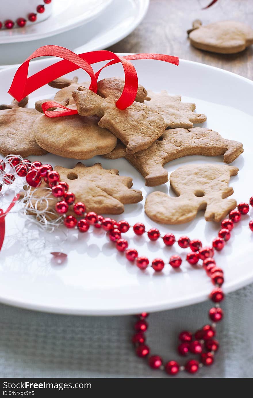 Christmas Gingerbreads with Red Ribbon at the White Plate