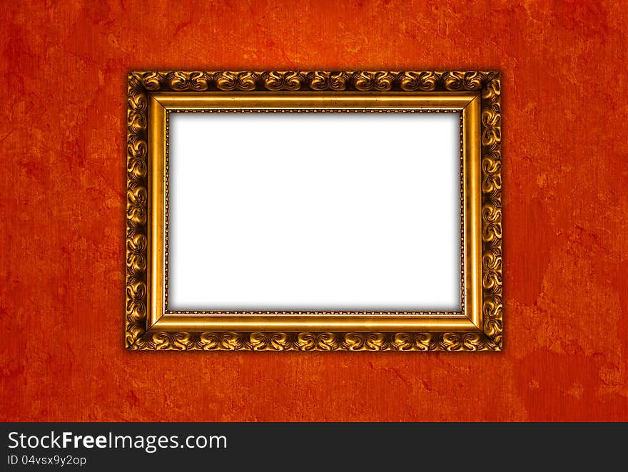 Golden vintage picture frame on red grungy wall