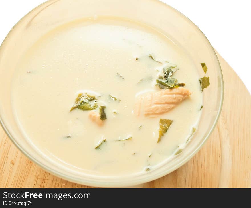 Cream soup with salmon and weed over white