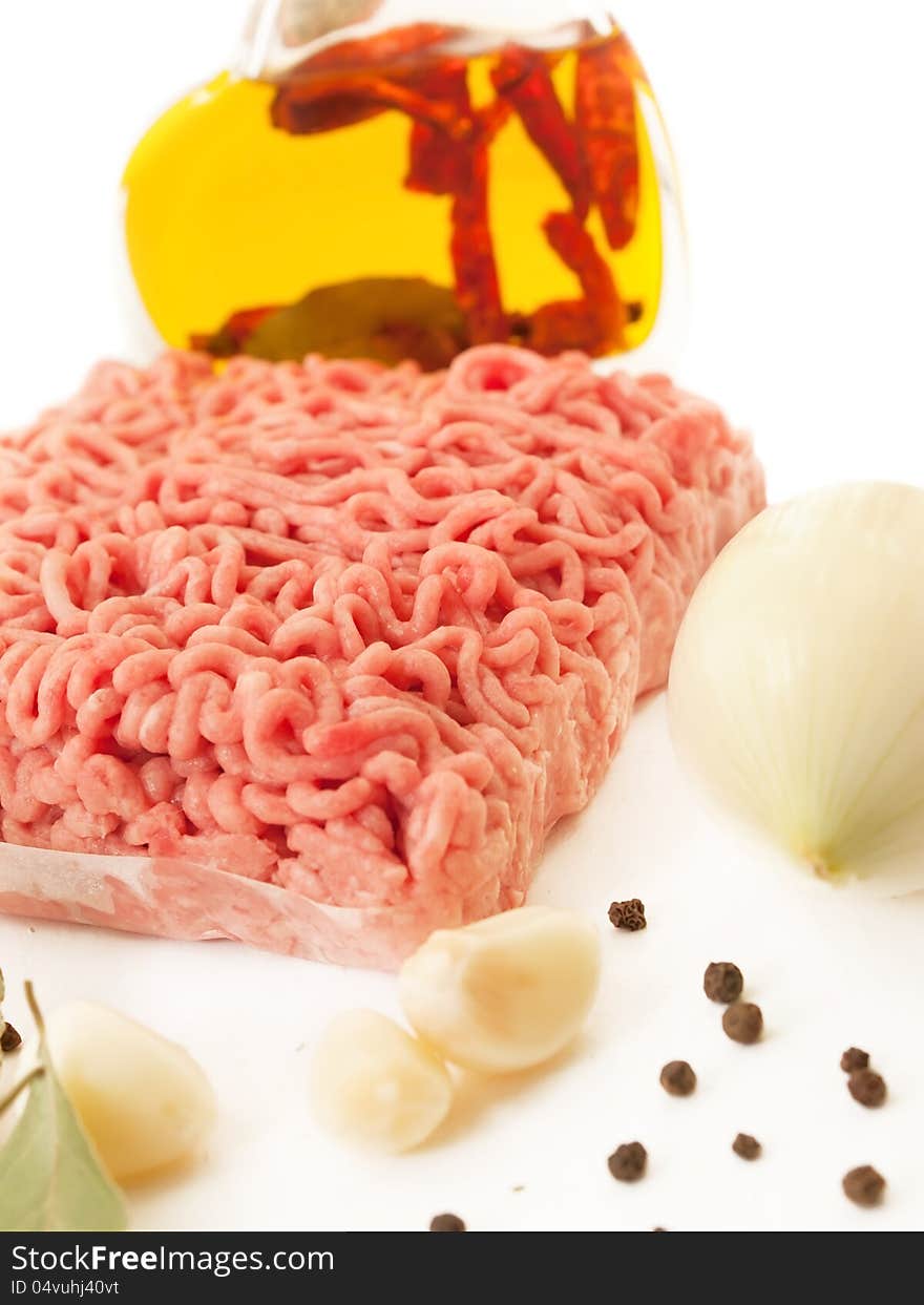 Minced meat with spices, garlic and onion on white background. Minced meat with spices, garlic and onion on white background