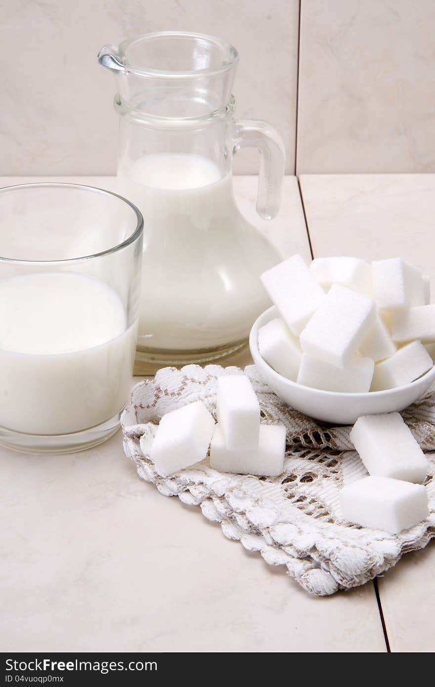 Jug and glass with milk and sugars