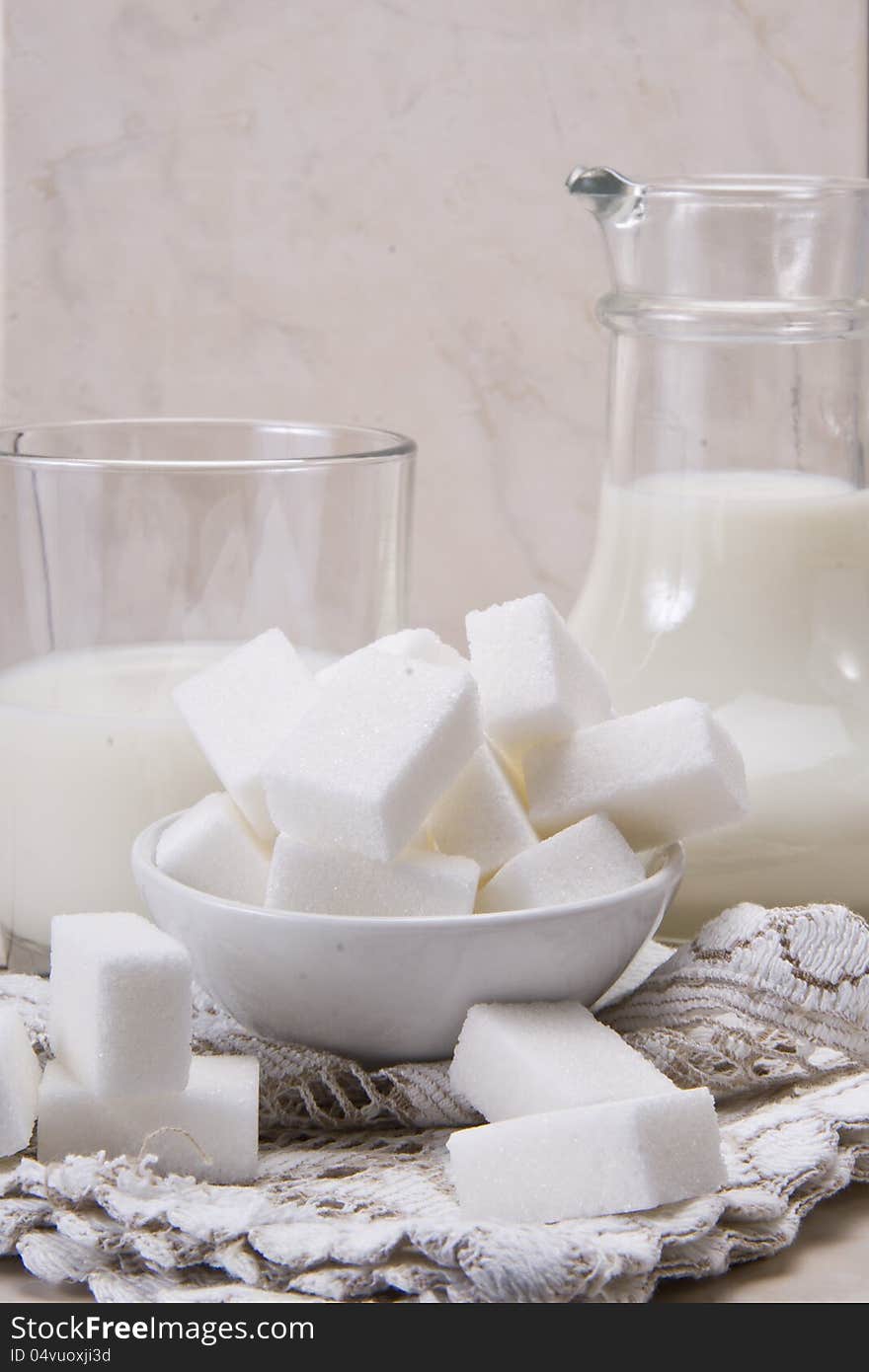 Jug and glass with milk and sugars