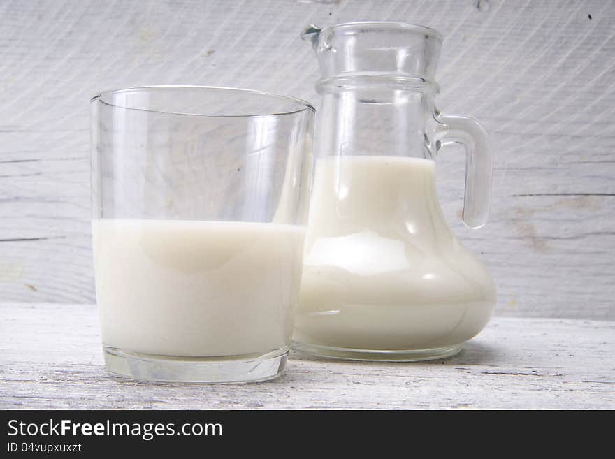 Jug and glass with milk and sugars