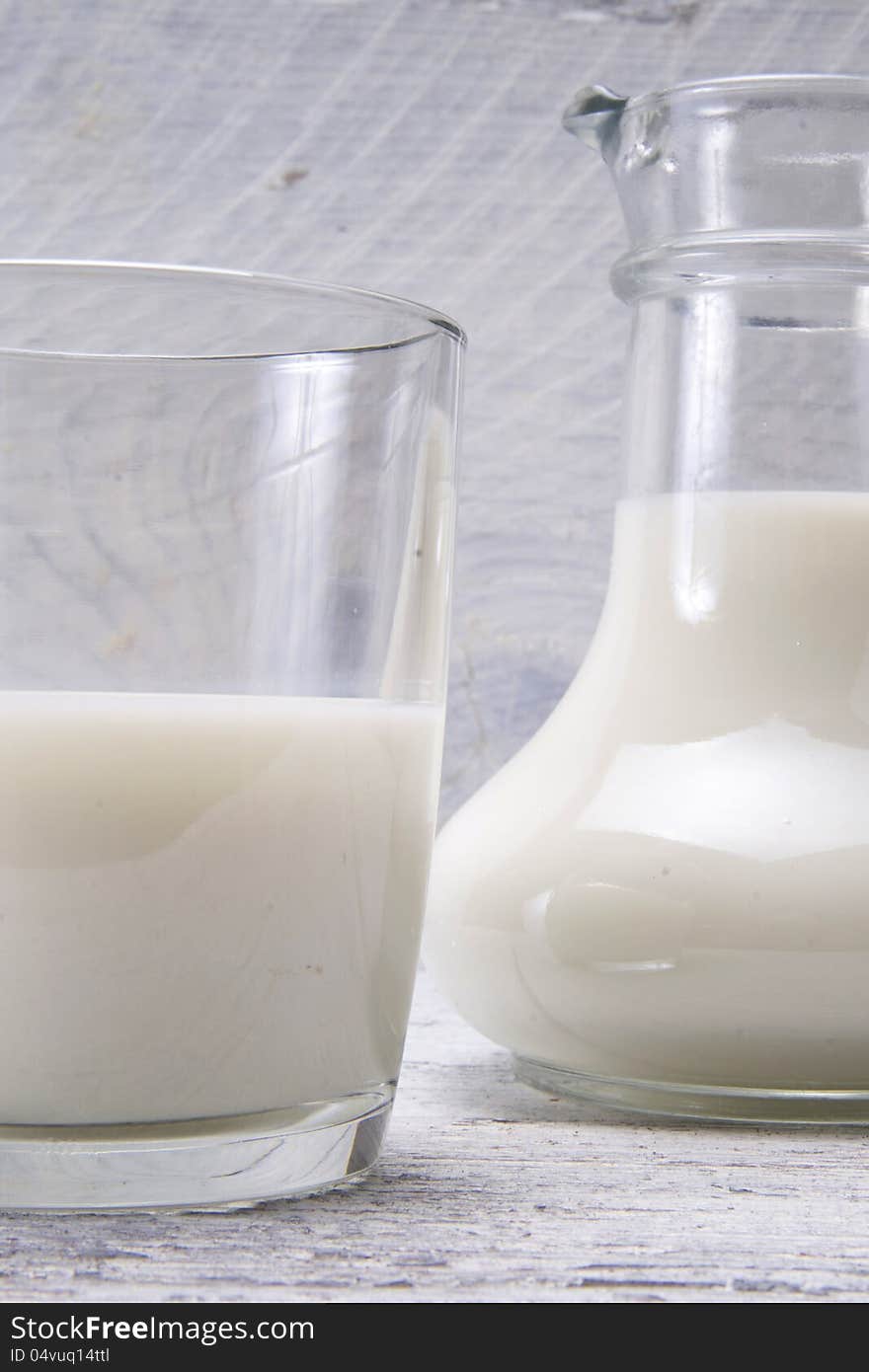 Jug and glass with milk and sugars