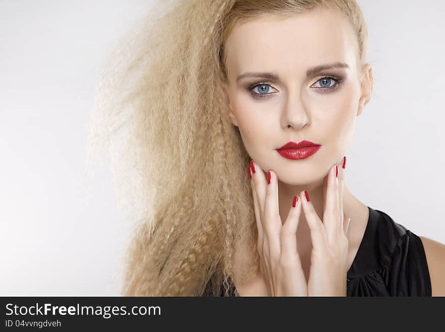 Young pretty woman with beautiful blond hairs and multicolor makeup on white background