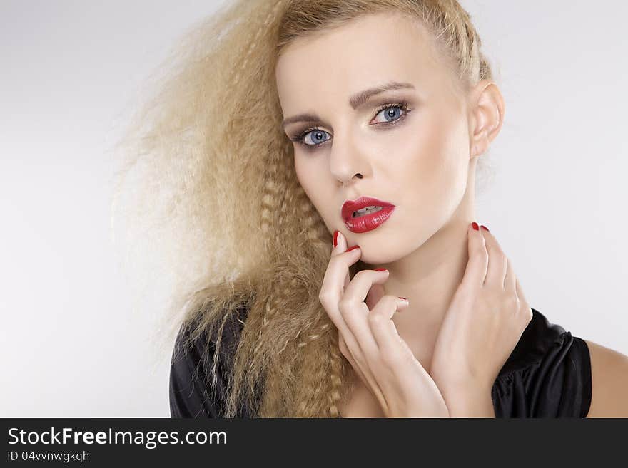 Young pretty woman with beautiful blond hairs and multicolor makeup on white background