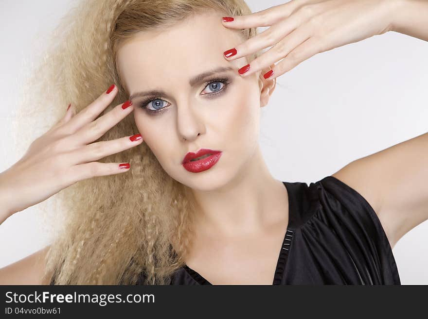 Young pretty woman with beautiful blond hairs and multicolor makeup on white background