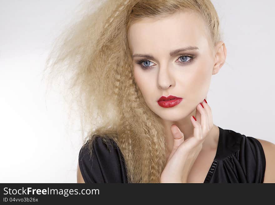 Young pretty woman with beautiful blond hairs and multicolor makeup on white background