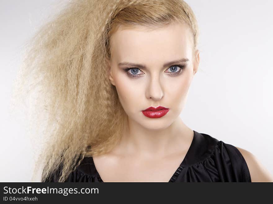 Young pretty woman with beautiful blond hairs and multicolor makeup  on white background