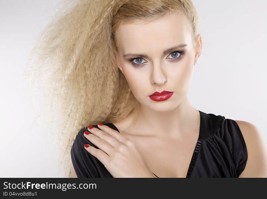 Young pretty woman with beautiful blond hairs and multicolor makeup on white background