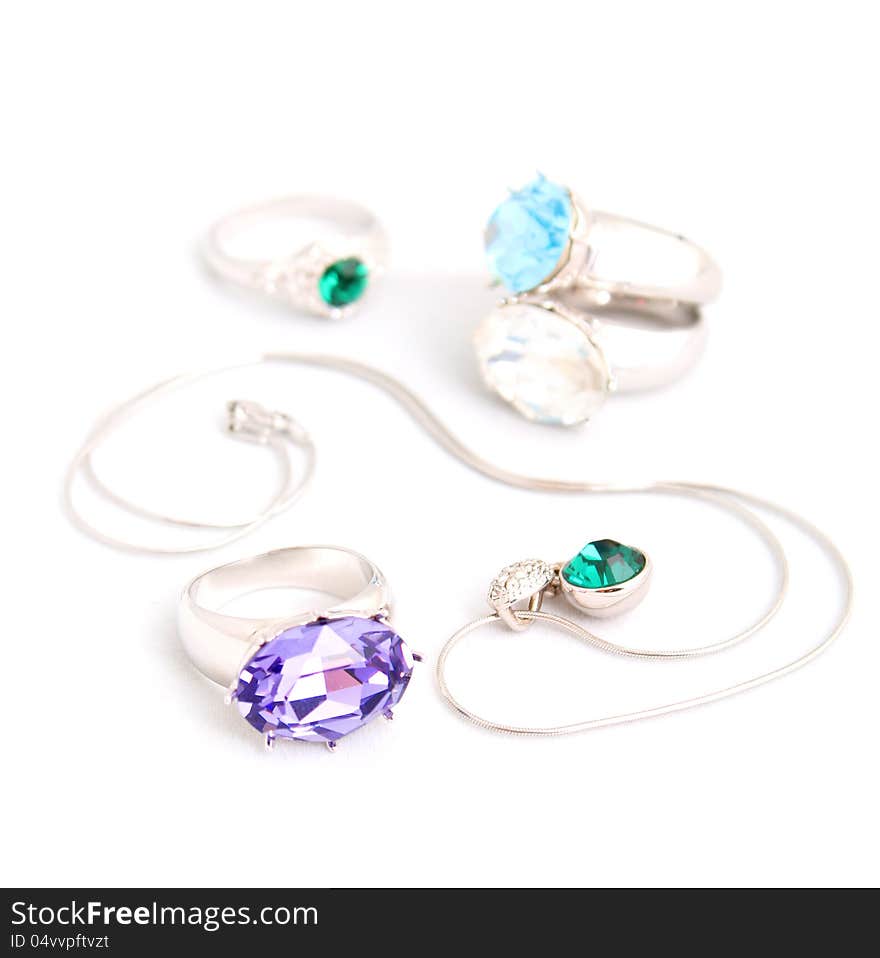 Jewelry on white background isolated. Rings and chains