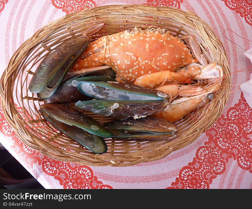 Crabs, shripms mussels assorted in straw plate. Crabs, shripms mussels assorted in straw plate