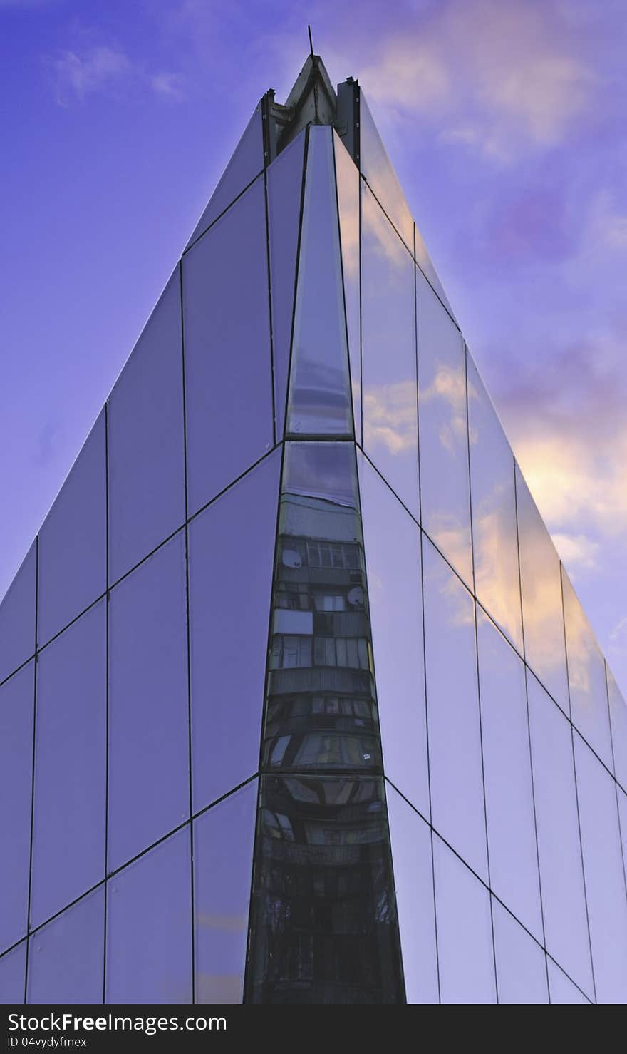 Photo of the modern building with reflection of an old building in it. Also modern building has a reflection of the sky on it surface. Photo of the modern building with reflection of an old building in it. Also modern building has a reflection of the sky on it surface.