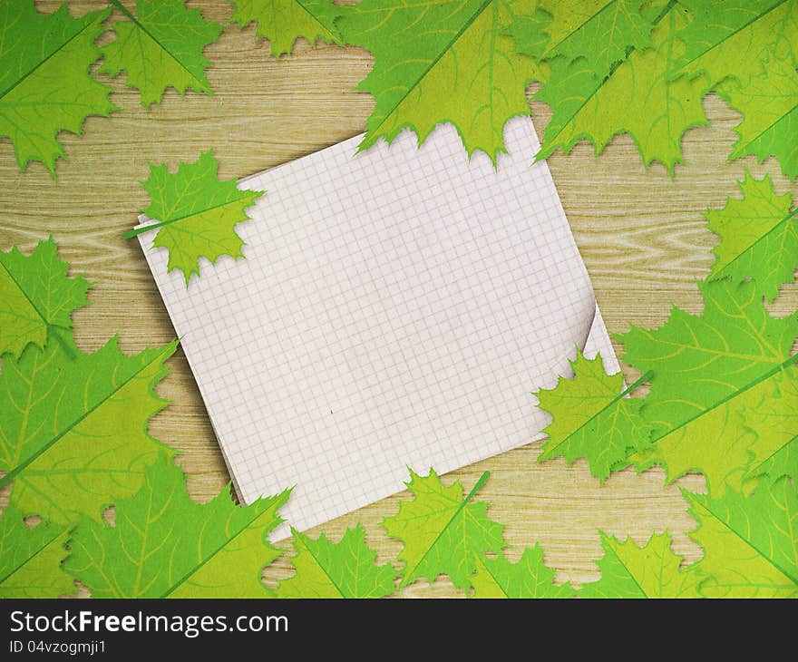 Maple leaves over wooden background