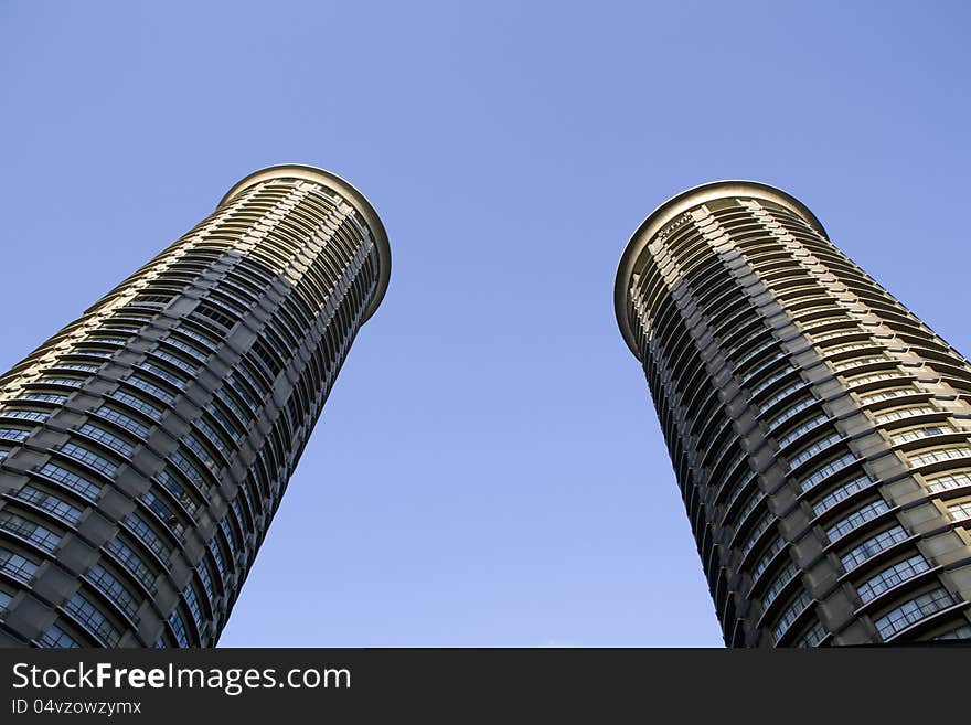 Two round buildings with blue sky. Two round buildings with blue sky