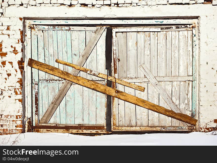 Board up gate of old cowshed. Board up gate of old cowshed