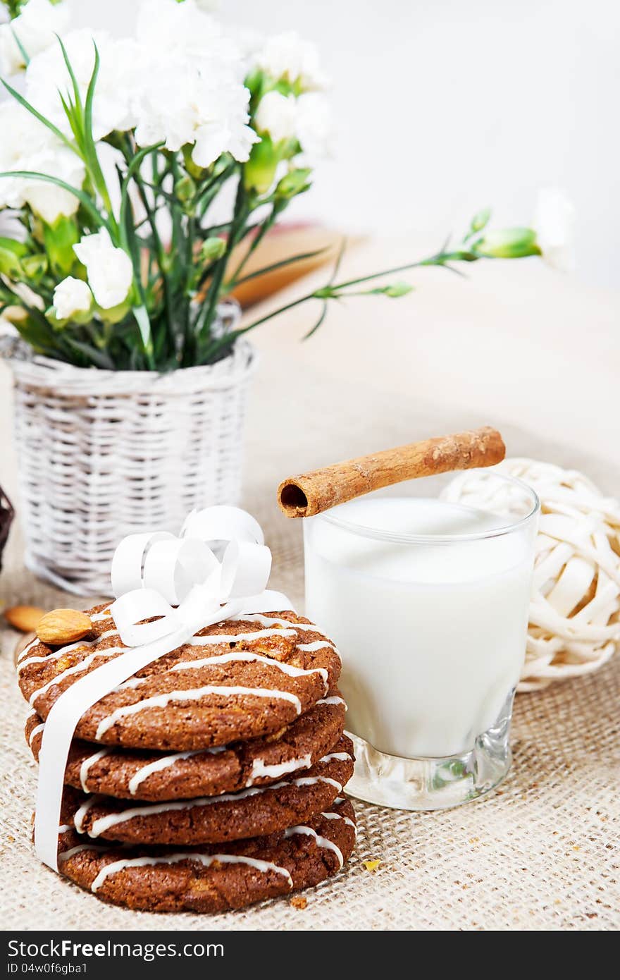 Natural homemade cookies wrapped in white ribbon, milk and flowers for someone special. Natural homemade cookies wrapped in white ribbon, milk and flowers for someone special