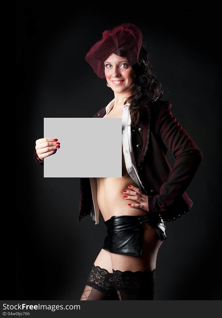 Portrait of sexy woman in erotic clothes showing perfect body on a dark background in the studio. Portrait of sexy woman in erotic clothes showing perfect body on a dark background in the studio